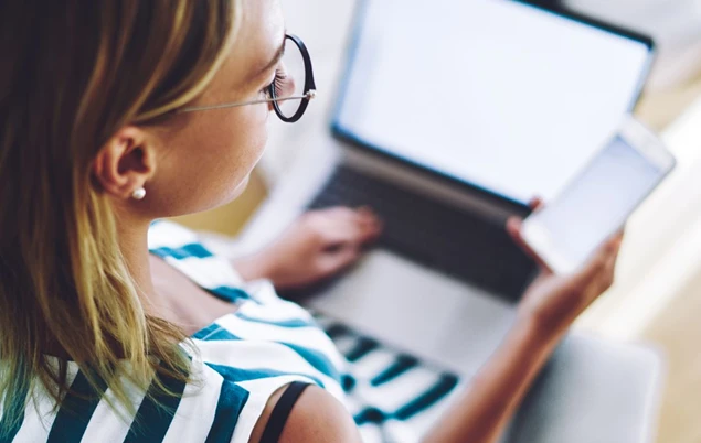 women using their phone and laptop