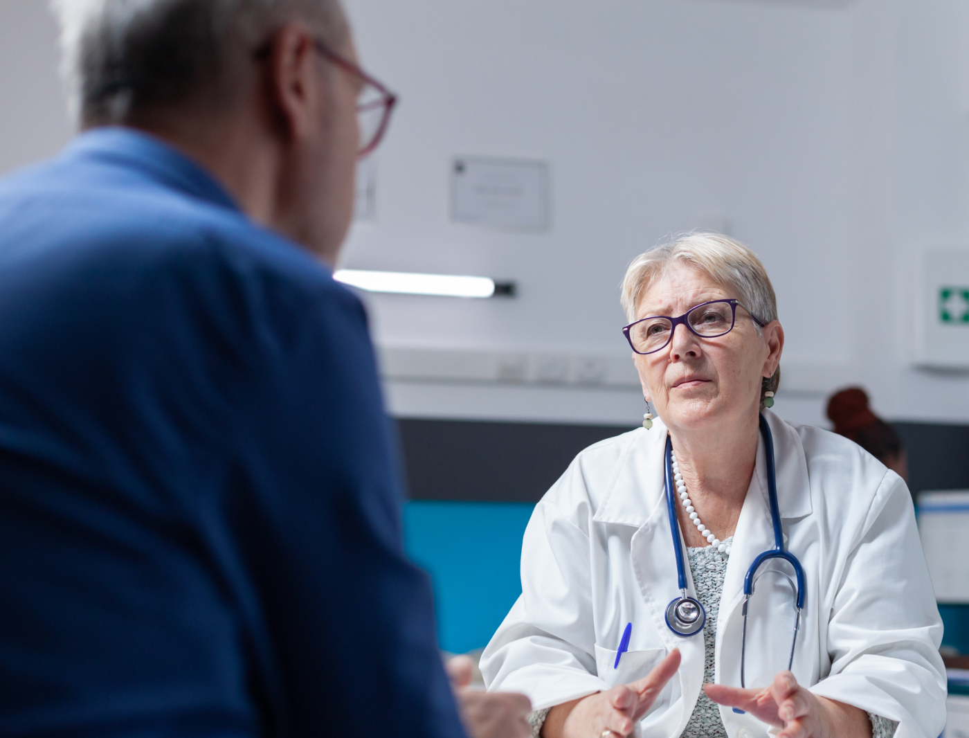 Doctor discussing a diagnosis with a senior patient during a clinic consultation