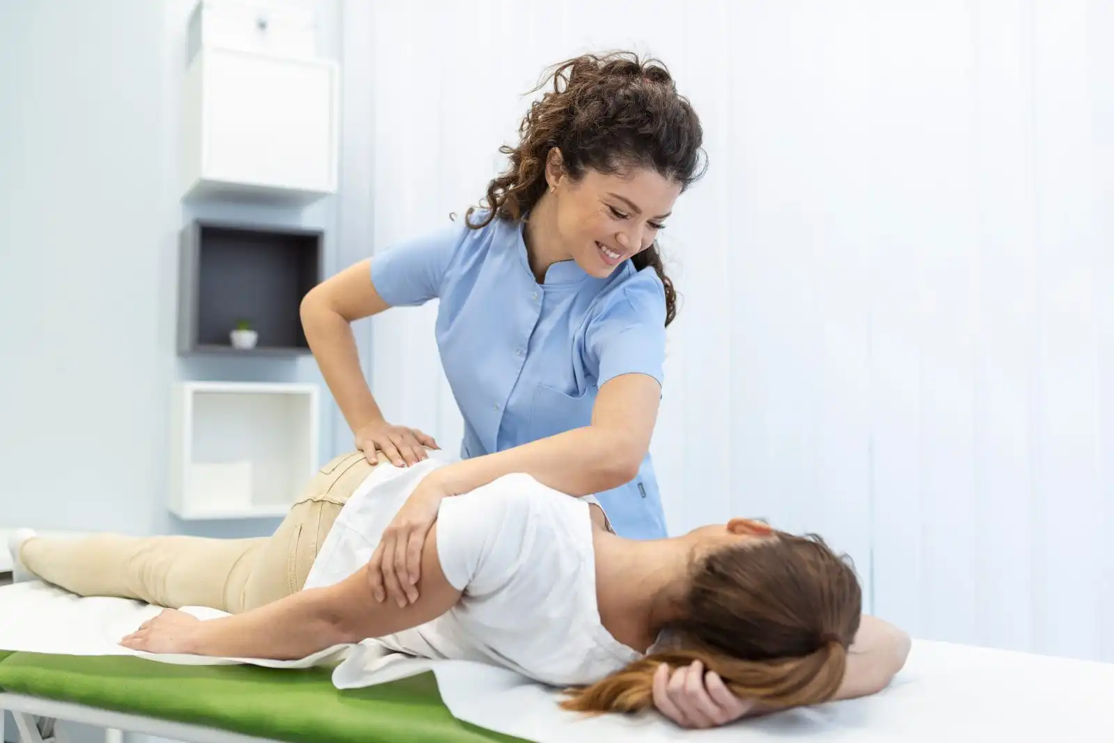 Chiropractor adjusting a patient on a treatment table
